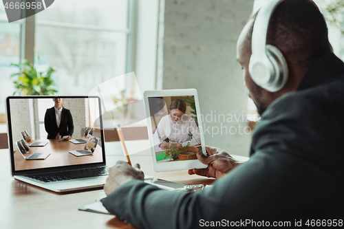 Image of Man working from home, remote office concept. Young businessman, manager doing tasks with laptop, has online conference.