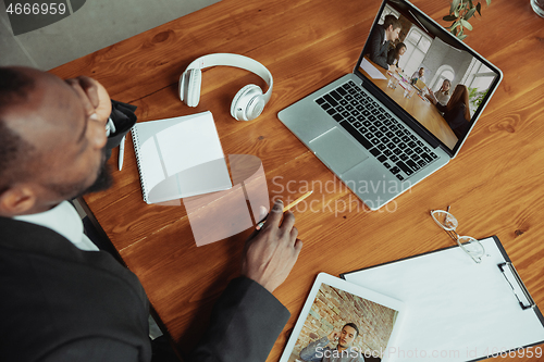 Image of Man working from home, remote office concept. Young businessman, manager doing tasks with laptop, has online conference.