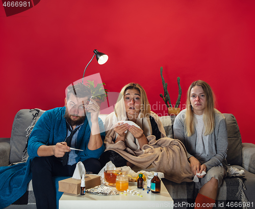 Image of Ill young people, friends or family with fever and cold look suffering at home