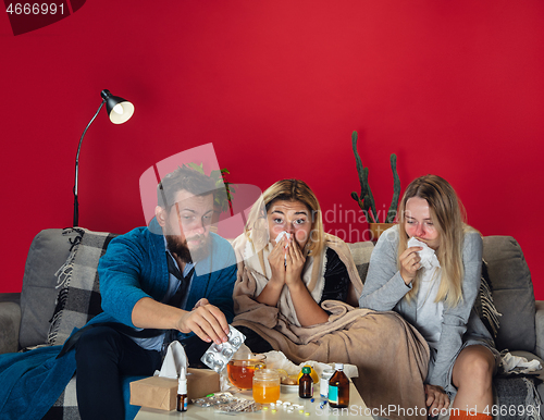 Image of Ill young people, friends or family with fever and cold look suffering at home