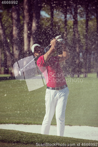 Image of golfer hitting a sand bunker shot