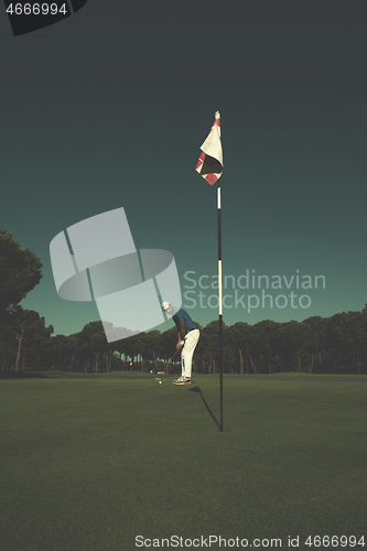 Image of golf player hitting shot at sunny day