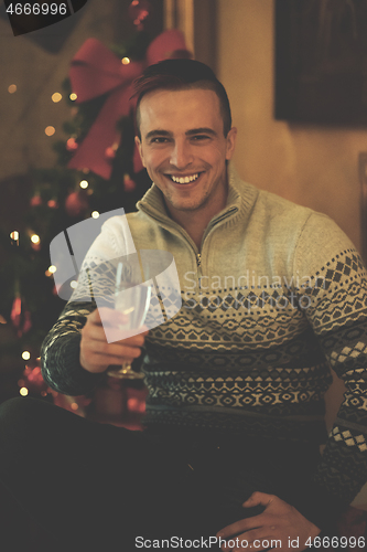 Image of young man with champagne glass  on party