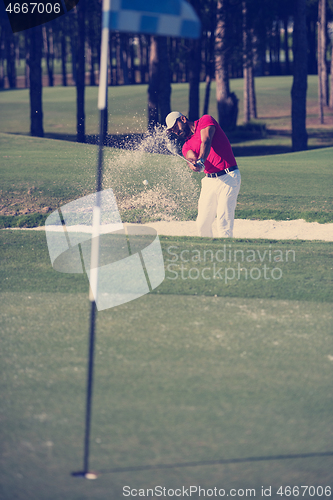 Image of golfer hitting a sand bunker shot