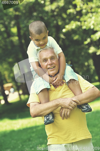 Image of happy grandfather and child in park