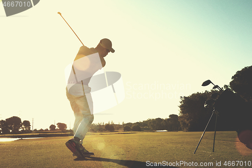 Image of golf player hitting shot with club