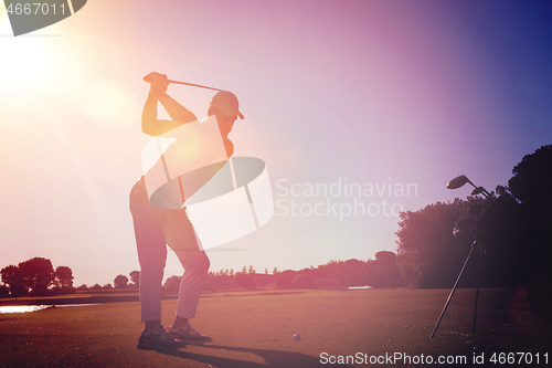 Image of golf player hitting shot with club