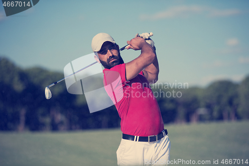 Image of golfer hitting a sand bunker shot