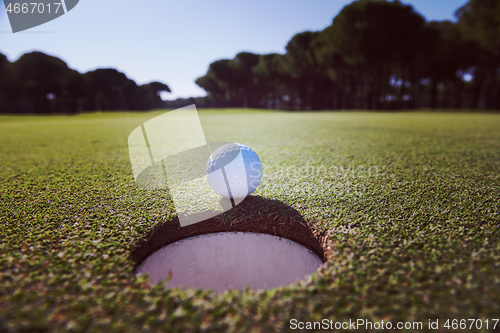 Image of golf ball in the hole