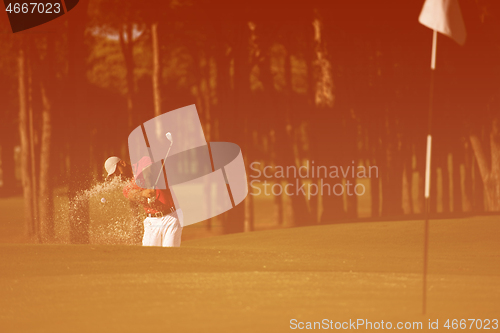 Image of golfer hitting a sand bunker shot