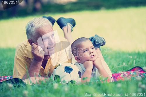 Image of grandfather and child have fun  in park