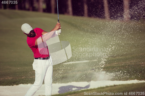 Image of golfer hitting a sand bunker shot