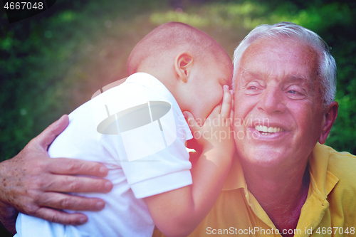 Image of happy grandfather and child in park