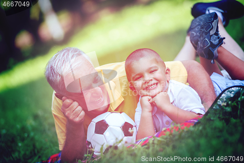 Image of grandfather and child have fun  in park