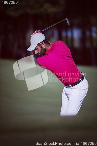 Image of golfer hitting a sand bunker shot