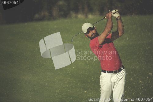 Image of golfer hitting a sand bunker shot