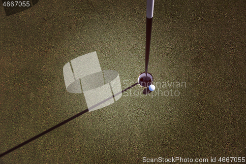 Image of top view of golf ball in the hole