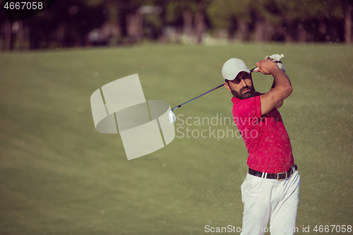 Image of golfer hitting a sand bunker shot