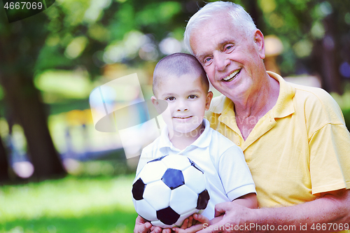 Image of happy grandfather and child in park