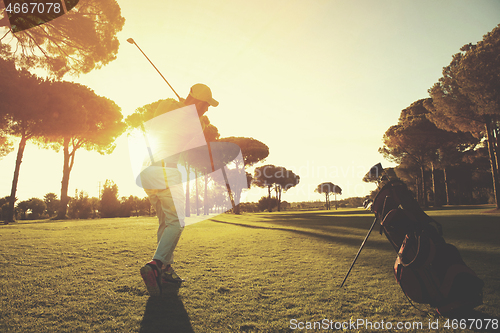 Image of golf player hitting shot with club