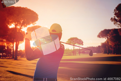 Image of golf player hitting shot with club