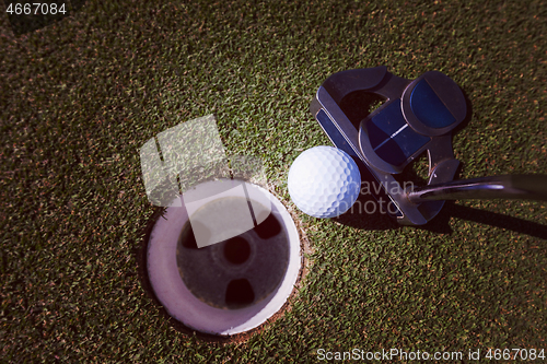 Image of hitting golf ball to hole