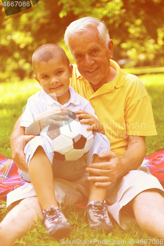 Image of happy grandfather and child in park