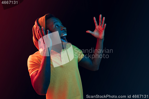 Image of The young handsome hipster man listening music with headphones