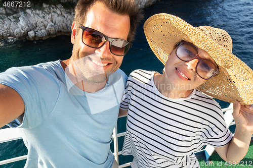 Image of Beautiful, romantic caucasian couple taking selfie self portrait photo on summer vacations traveling by cruse ship ferry boat.