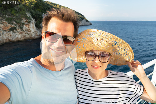 Image of Beautiful, romantic caucasian couple taking selfie self portrait photo on summer vacations traveling by cruse ship ferry boat.