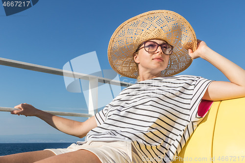 Image of Beautiful, romantic blonde woman taking selfie self portrait photo on summer vacations traveling by cruse ship ferry boat.