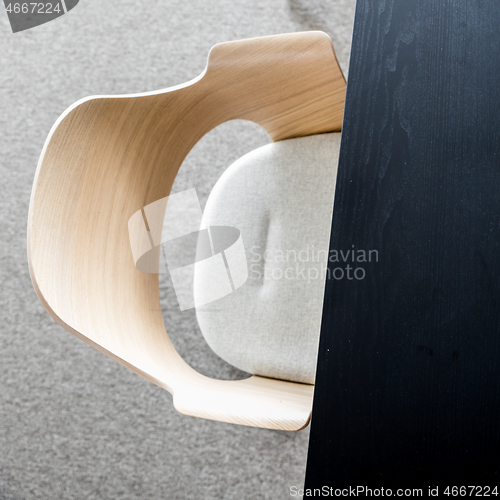 Image of Designers armchair by black office desk. Modern minimalist workplace