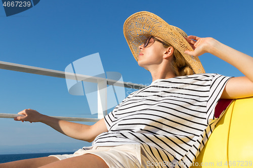 Image of Beautiful, romantic blonde woman taking selfie self portrait photo on summer vacations traveling by cruse ship ferry boat.