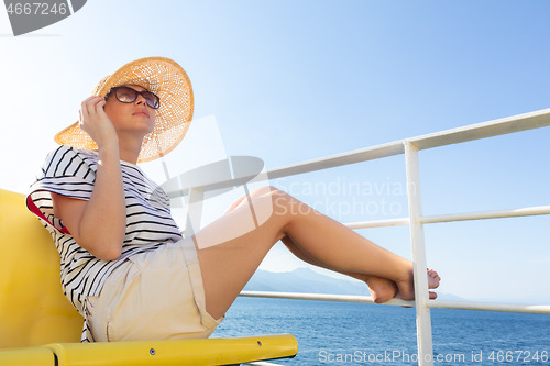Image of Beautiful, romantic blonde woman taking selfie self portrait photo on summer vacations traveling by cruse ship ferry boat.
