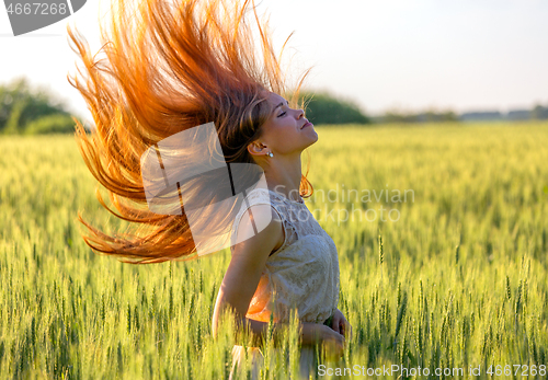 Image of girl with blowing red hair