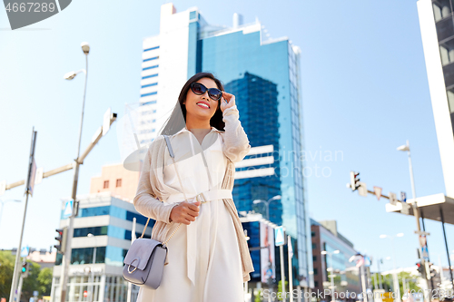 Image of happy smiling young woman on city street