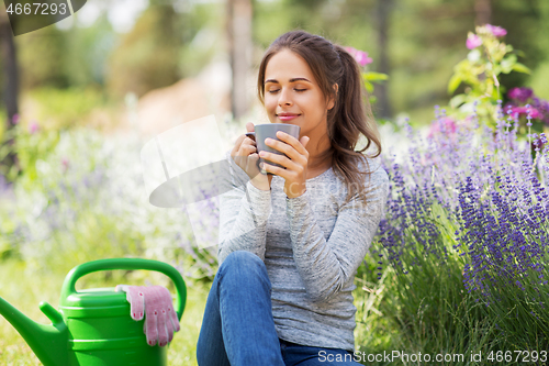 Image of woman drinking tea or coffee at summer garden