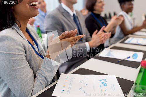 Image of happy people applauding at business conference