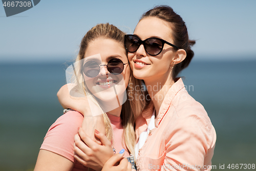 Image of teenage girls or best friends at seaside in summer