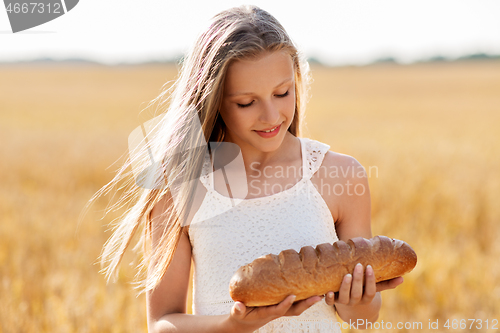 Image of girl with loaf of white bread on cereal field