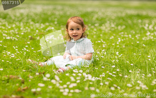 Image of happy little baby girl at park in summer