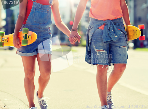 Image of close up of young couple with skateboards in city