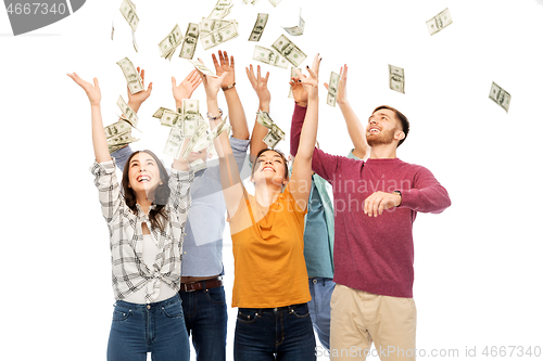 Image of happy friends picking money falling from up above