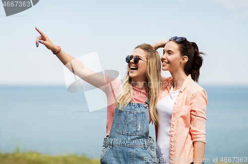 Image of teenage girls or best friends at seaside in summer