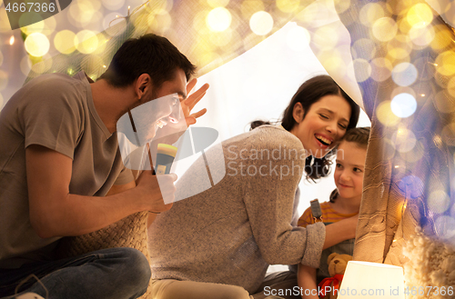 Image of father telling scary stories to his daughter