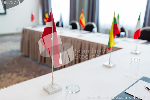 Image of flags at international conference boardroom