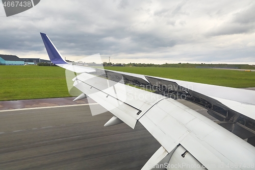 Image of Landing plane wing flaps and spoilers extended