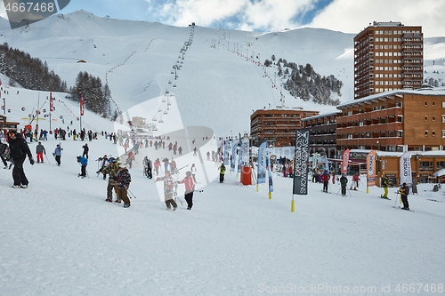 Image of Skiing slopes, with many people