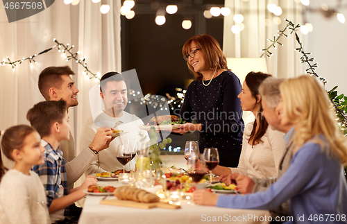 Image of happy family having dinner party at home