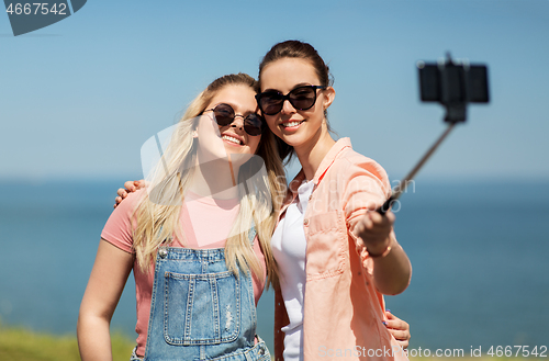 Image of teenage girls or friends taking selfie in summer